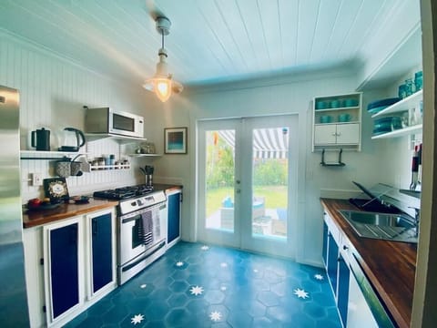 Full-size kitchen with gas stove that opens onto back yard