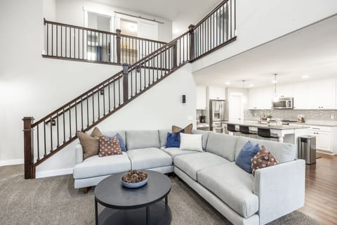 The main floor living room houses a 65-inch tv with an open floor plan