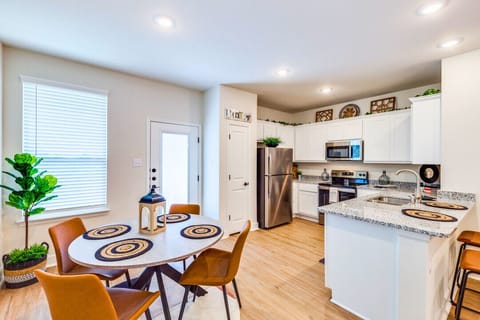 Cook with ease in a modern kitchen featuring essential appliances, sleek countertops, and a built-in heater—perfect for preparing meals comfortably any time of year.