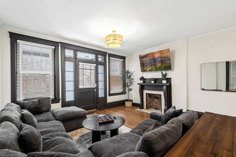 Living Room: Relax in our bright living space, featuring a comfy sofa, wooden floors, and plenty of natural light to make you feel right at home.