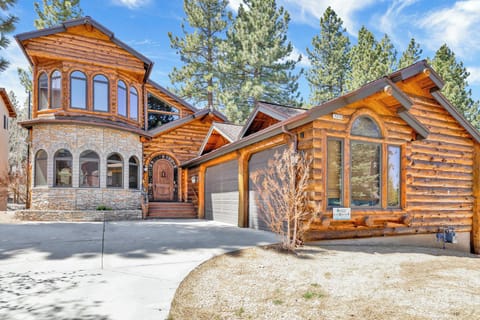 Welcoming cabin entry surrounded by towering pine trees, offering fresh mountain air and a peaceful forest setting—the perfect first impression for your Big Bear Lake getaway.