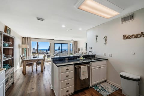 The fully equipped kitchen features granite countertops and stainless-steel appliances.