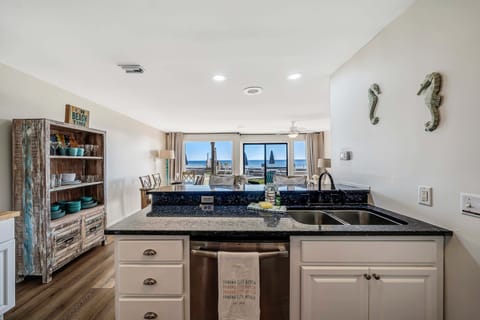 The fully equipped kitchen features granite countertops and stainless-steel appliances.