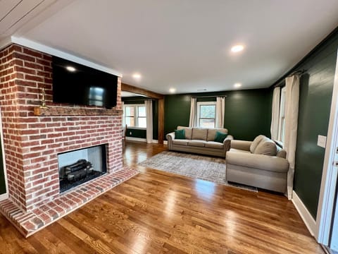 Open floor plan with kitchen, living and dining connected. TV extends from wall.