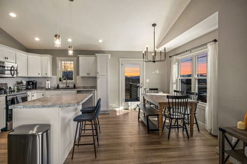 The kitchen and dining area have seating for 8 people total. 6 people can fit at the dining table and an additional 2 can sit at the kitchen island.