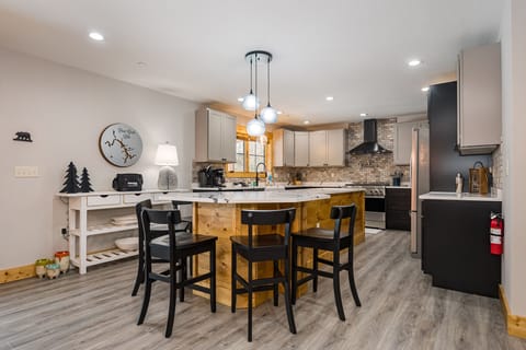 Well-equipped kitchen with island seating for five.