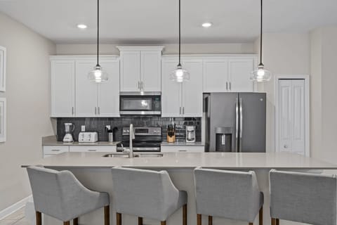 Fully equipped kitchen, stainless steel appliances, and a central island