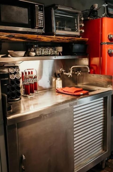 Kitchenette with convection toaster oven, mini fridge, keurig, & microwave.