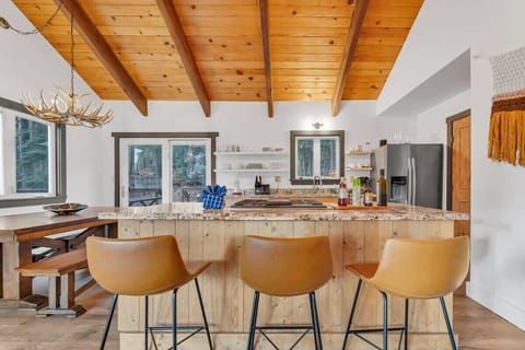 A kitchen bar with seating for 3 bridges the living room and kitchen together and provides a comfortable spot for grabbing a snack or enjoying your morning cup of coffee.
