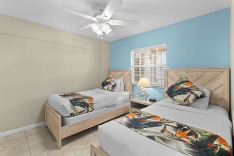 Drift off easily in bright twins with a cozy bedside lamp.