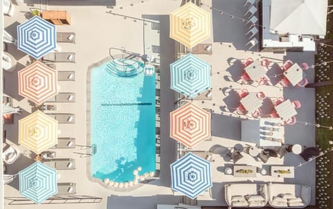Soak up the scene from above—umbrellas, water, and sunshine.
