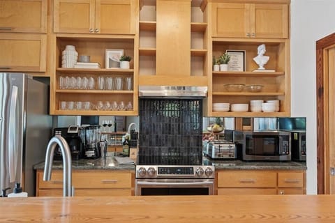 Cooking made easy and stylish—wooden cabinets and all the essentials for your perfect stay.