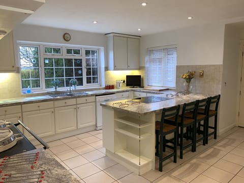 LARGE KITCHEN LEADING ON TO THE UTILITY ROOM.