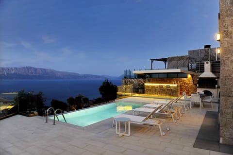 Outdoor private pool area with barbeque, offering amazing sea views