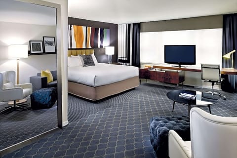 Settle into an airy suite with dedicated desk and TV.