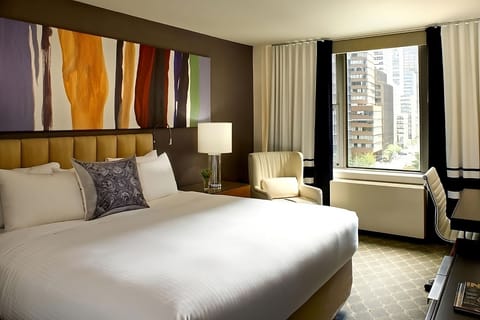 Wake up to sunshine and city views from a plush bed.