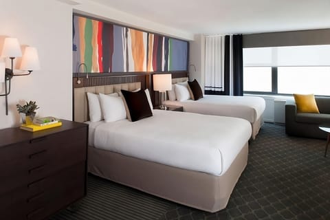 Stretch out in two plush beds beneath bold, modern art.