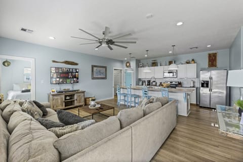 Open living space with cozy seating and a fully equipped modern kitchen.