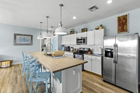 Modern kitchen with a large island and seating, ideal for social cooking.