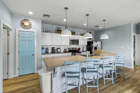 Experience the charm of our fully stocked coastal kitchen with a stylish island and bar seating.