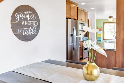 Kitchen - fridge, oven, stove, microwave, dishwasher, bar seating,  table seating.