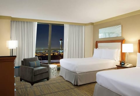 Unwind in plush beds while city lights sparkle below.