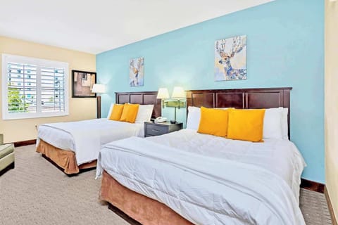 Relax in comfort with soft bedding, cheerful décor, and 2 Queen beds