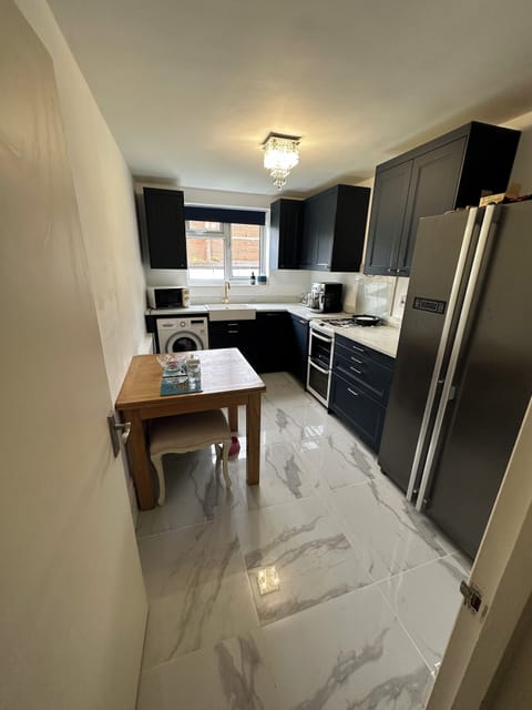Kitchen, dishwasher, washing machine and American fridge freezer, dining table