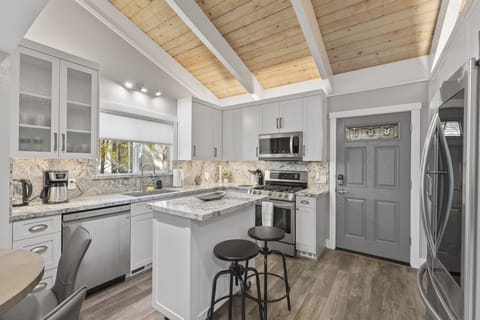 Kitchen area with stools for additional seating on the island