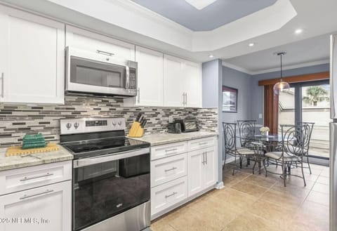 - Kitchen offers full appliances with white cabinets and chic details.  
- Cozy breakfast nook lets you enjoy casual meals in comfort.  
- Perfect for morning coffee or intimate dinners at home.  