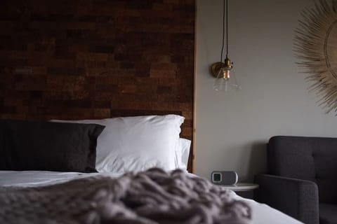 Relax into plush pillows beside warm textures and ambient glow.