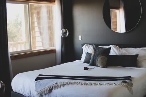 Relax under soft lighting in a serene, design-forward bedroom