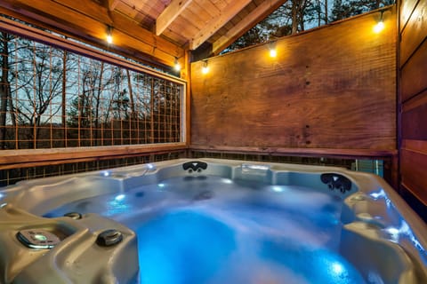 Relax in your private hot tub oasis in Sevierville! Surrounded by nature, glowing lights, and rustic charm—perfect for unwinding after a day of adventure. Book your serene escape today!