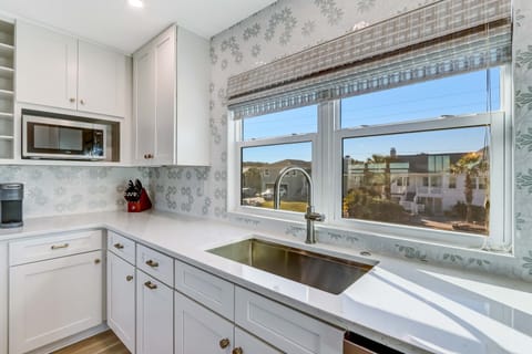 The new Shaker cabinets are fully stocked with high end dishes and cookware. 