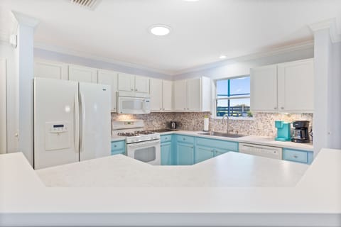 Large kitchen with French door refrigerator and gas cooking