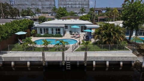 Aerial view of backyard oasis and sparkling saltwater pool and dock