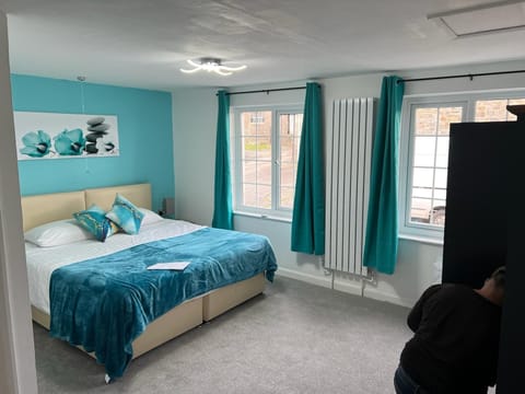 Bedroom 1 with ensuite bathroom and sofa bed.