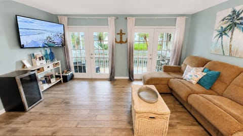 French doors lead to a balcony with canal and golf course views.
