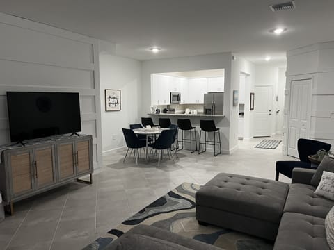 Living Room and Kitchen. Games, books are stocked in TV cabinet. 