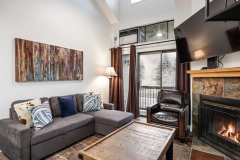 - Cozy living room with fireplace and mountain views  
- Smart TV and plush seating for family gatherings  
- Perfect ski condo with modern rustic style
