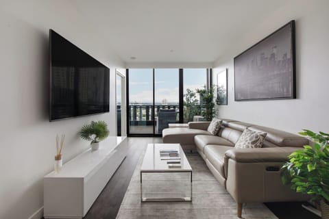 Get comfortable in the living room. Relax on the sofas while enjoying the large wall-mounted TV.