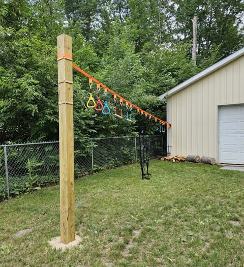 Fenced-in backyard with an obstacle course for children