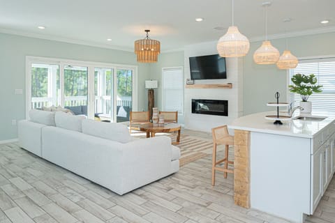 Gather with loved ones in this inviting open-plan living area, where the kitchen and living room flow together effortlessly.
