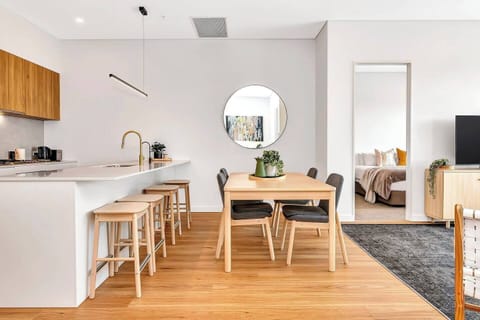 Guests can enjoy meals together in the open-plan living and dining area, which includes a four-seater table setting. 
