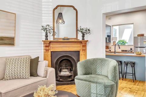 Get cosy in the lounge room, with plush sofa seating and gorgeous character details, including a fireplace.
