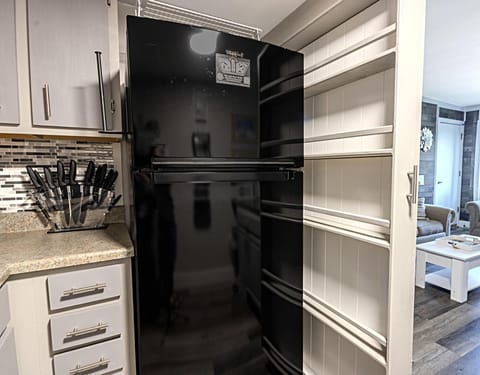 Rollout kitchen pantry by the fridge provides plenty of storage space for your dry goods.