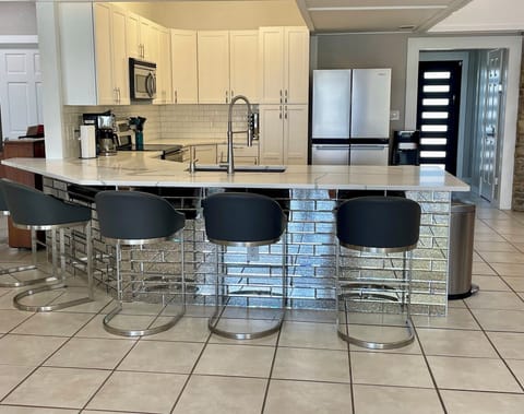 Full Stocked Kitchen with Bar Sitting