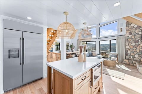 Bright open concept kitchen with all  cooking essentials and stainless steel appliances.