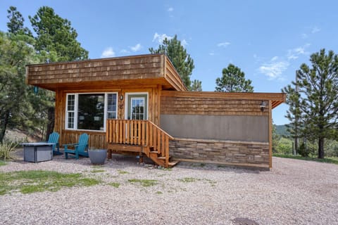 Relax in Adirodacks in front of your cozy cabin.