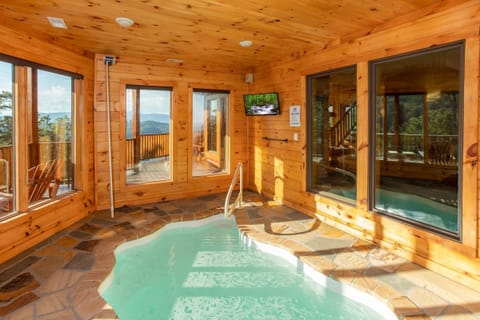 Indoor pool room with a TV